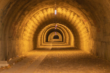 pedestrian tunnel illuminated by yellow lamp