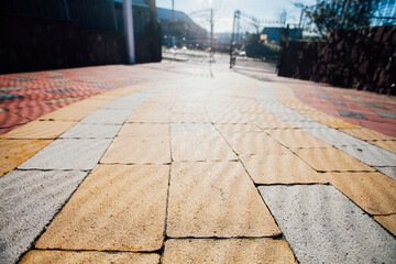 Stone pavement in perspective. Stone pavement texture. Granite cobblestoned pavement background....
