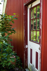 Fototapeta na wymiar White door on a red wall country style