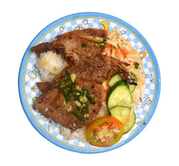 Closeup of vietnamese food: steamed rice dish with meat pie and BBQ pork chop