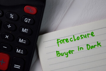 Obraz premium Foreclosure Buyer in Dark text write on a book isolated wooden table.