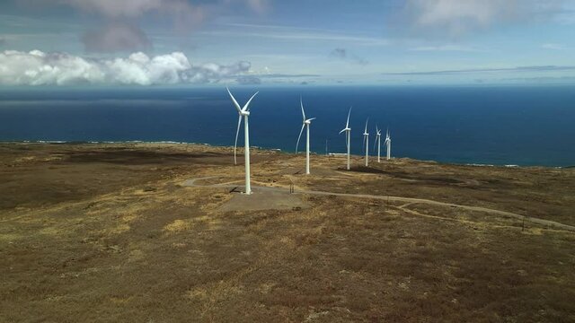 Drone aerial shot 4k. Wind turbines generating clean renewable energy, eco solution to climate change.