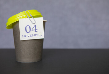 Coffee paper cup with calendar dates for November 04, fall season. Time for relaxing breaks and vacations.