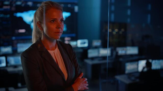 Emotional Female Flight Controller Being Nervous Before a Very Important Space Rocket Launch. Beautiful Portrait with a Reflection in a Mission Control Center. Computer Screens in the Background.