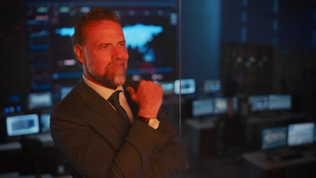 Emotional Happy Male Flight Controller Being Nervous Before a Very Important Space Rocket Launch. Powerful Portrait with a Reflection in a Mission Control Center. Computer Screens in the Background.