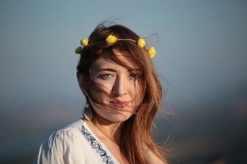 Close up portrait of a natural woman smiling with hat.