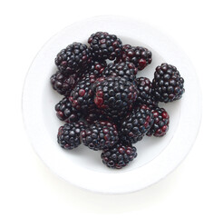 blackberries in white plate on white