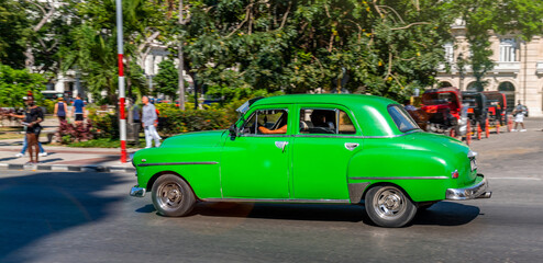Vintage classic American oldtimer car in the old town of Havana, Cuba. Colorful scene of the vibrant streets of the famous capital.