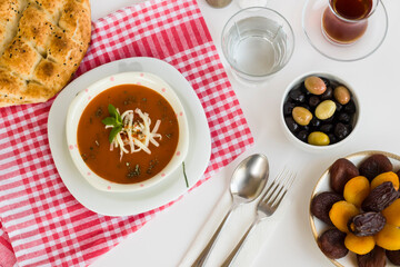 Traditional Turkish Tomato Soup with cheese and fresh mint garnised,close-up taken on Ramadan,Iftar Table.