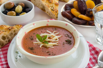 Traditional Turkish Tomato Soup with cheese and fresh mint garnised,close-up taken on Ramadan,Iftar Table.