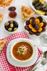 Traditional Turkish Tomato Soup with cheese and fresh mint garnised,close-up taken on Ramadan,Iftar Table.