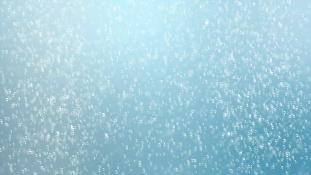 Fine bubbles rising in blue clean liquid or drink. Abstract bubble background. Seamless loopable background.