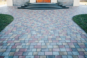 Stone pavement in perspective. Stone pavement texture. Granite cobblestoned pavement background....