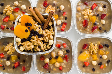 Traditional Turkish Dessert is Noah's Pudding,Asure in foil containers ,take away package,on the white surface with copy space.
