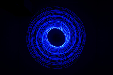 Wonderful and abstract circular and parabolic patterns drawed various light trails with LED ball lights on a dark back ground,Pendulum. 