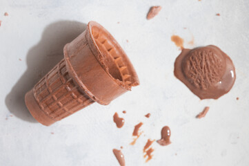 Coffee ice cream on white background, with sunlight melting ice cream