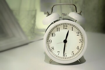 white round vintage alarm clock on white table
