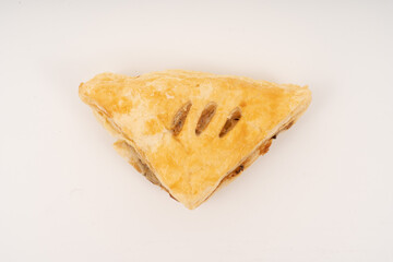 Puff pastry triangles on white background.