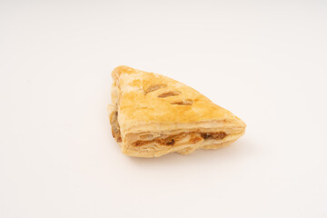 Puff pastry triangles on white background.