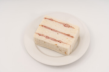 Sandwich made by white bread, ham and mayonnaise on white background.
