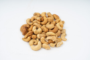 Tasty cashew nuts on white background.
