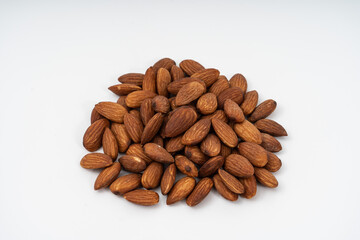 big raw peeled almonds on white background.