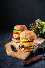 Fast food. A big burger and on a dark background.