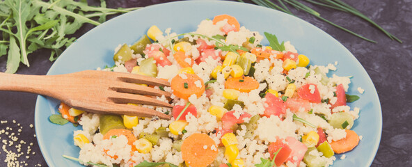 Salad with vegetables and couscous groats. Light and healthy meal containing vitamins and minerals