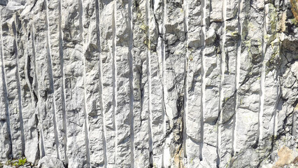 a fragment of grey rock with traces of processing