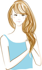 髪にヘアケア商品をつける女性