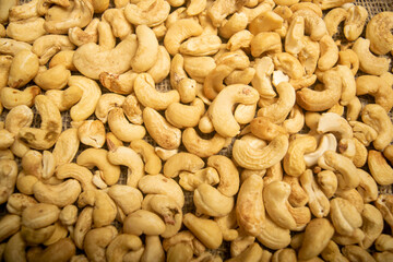 Cashew nuts scattered surface texture. Close up.