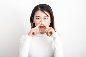 The girl in white who pinches her nose