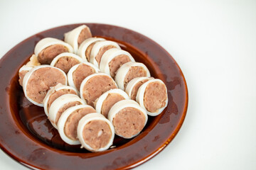 Stuffed Squid slice stack on disk photo on the white background