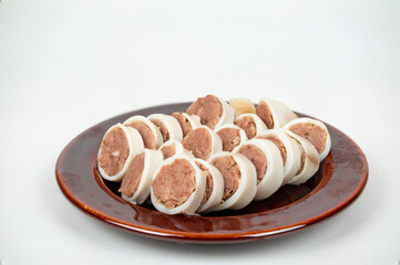 Stuffed Squid slice stack on disk photo on the white background