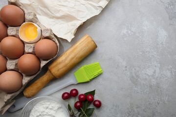 Ingredients baking flour eggs rolling pin berries kitchen textiles on gray background. Cookie pie or cake recipe mockup. Preparing for culinary baking.