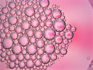 abstract background with pink bubbles oil ,macro image ,blurred sweet color for card design ,bright wallpaper, shiny water droplets