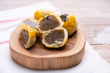 Chinese pastry bakery topping with black and white sesame  seeds on wooden tray