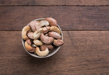 Cashews nuts with shells,homemade roasted process on wooden background