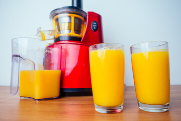 raw food diet concept oranges and juicemachine in white background