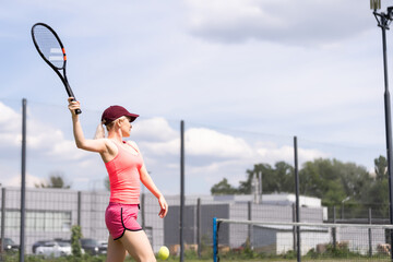 Woman playing tennis and waiting for the service