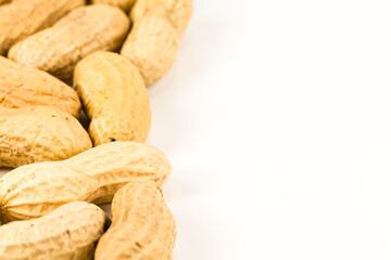some dried and closed peanuts isolated on white background with copy space on the right