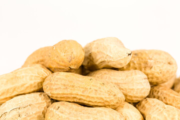 some dried and closed peanuts isolated on white background with copy space above