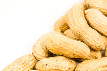 some dried and closed peanuts isolated on white background with copy space on the left