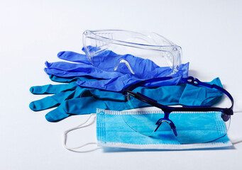 medical protective equuipment, nitrile gloves, mask for the face, blue, goggles, on a white background, isolated, corona, hygiene,