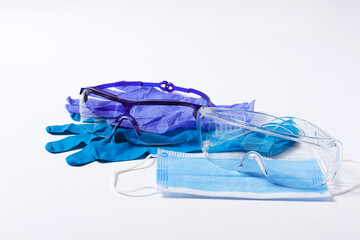medical protective equuipment,  nitrile gloves, blue, mask for the face, goggles, on a white background, horizontal, 