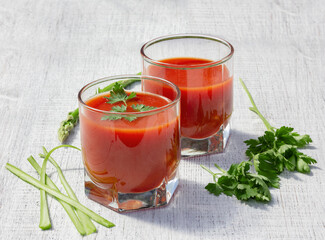 glasses with tomato juice parsley and celery