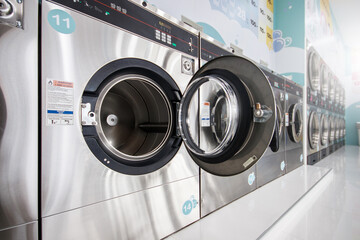 Close-Up multiple Industrial Washing Machines in Laundry shop, Washing with hot and cold water keeps clothes clean and trendy.