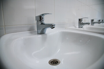 Fototapeta premium Close-up of row modern ceramic wash hand basins