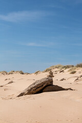 Fototapeta na wymiar Stack Of Pebble On Sandy Beach