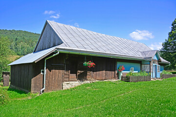 Traditional wooden rural house in summer sunny day, Ropki village near Wysowa Zdroj, Low Beskids  (Beskid Niski), Poland